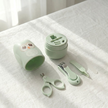 WhisperCare™ baby care kit in green, featuring an owl-shaped case, baby nail clippers, safety scissors, and a nail file.