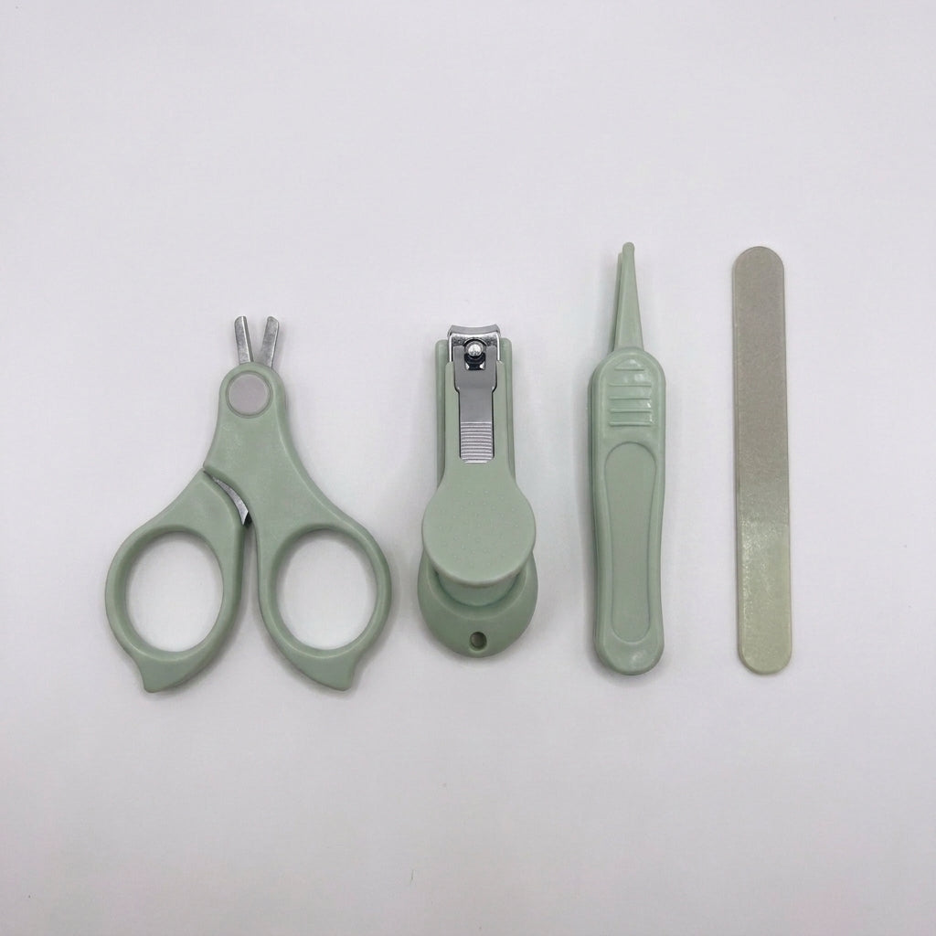 A set of four light sage green pet grooming tools, including nail clippers, a nail file, and a small brush, arranged horizontally on a plain white background.