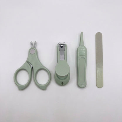 A set of four light sage green pet grooming tools, including nail clippers, a nail file, and a small brush, arranged horizontally on a plain white background.