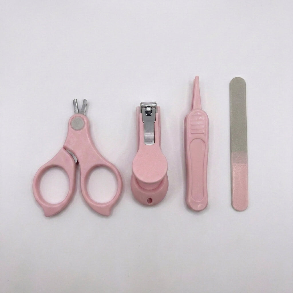 A pink pet grooming kit with four tools: nail clippers, a nail file, a small brush, and a nail trimmer, arranged on a plain white background.